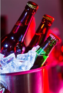 Several beers in an ice bucket
