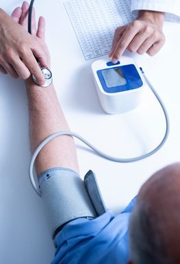 Image of an arm and a blood pressure machine