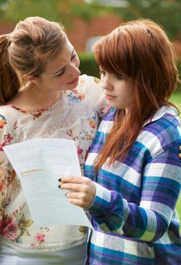 Girl with mother looking at exam results