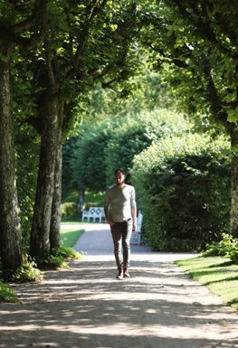 A person walking on a path surrounded by trees