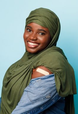 Woman showing shoulder with a plaster on it.